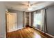 Bedroom featuring gray walls, hardwood floors, closet, and a window with natural light at 3205 Broyhill Cir, Raleigh, NC 27604