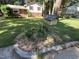 Landscaped front yard featuring a unique birdhouse and flower bed, adding charm to this inviting residential property at 3205 Broyhill Cir, Raleigh, NC 27604