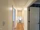 Hallway featuring a wooden floor, neutral paint, and doorways leading to various rooms of the home at 3205 Broyhill Cir, Raleigh, NC 27604