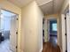Hallway with hardwood floors, white doors, and access to multiple rooms at 3205 Broyhill Cir, Raleigh, NC 27604