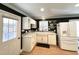 Well-lit kitchen showcasing white cabinets, a farmhouse sink, and modern appliances, combining style and functionality at 3205 Broyhill Cir, Raleigh, NC 27604