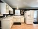 Stylish kitchen featuring white cabinetry, a farmhouse sink, and stainless steel appliances, blending modern design with classic touches at 3205 Broyhill Cir, Raleigh, NC 27604