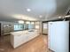 Open kitchen layout showcasing an island cooktop, ample cabinetry, and modern lighting fixtures at 3205 Broyhill Cir, Raleigh, NC 27604