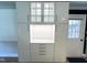 Bright white kitchen cabinet with glass doors and drawers offers ample storage and modern design at 3205 Broyhill Cir, Raleigh, NC 27604