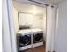 Convenient laundry room with modern washer and dryer, and upper cabinet storage at 3205 Broyhill Cir, Raleigh, NC 27604