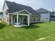 A spacious backyard features lush green grass, a covered patio with white columns, and well-maintained landscaping at 33 Black Walnut Dr # 185, Garner, NC 27529