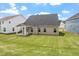 Green backyard shows the home's exterior, patio, and manicured lawn at 33 Black Walnut Dr # 185, Garner, NC 27529