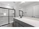 Well-lit bathroom with a gray vanity, quartz countertop, and glass shower at 33 Black Walnut Dr # 185, Garner, NC 27529