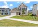 Charming two-story home featuring a stone facade, two-car garage, and a well-manicured lawn at 33 Black Walnut Dr # 185, Garner, NC 27529
