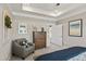 Stylish main bedroom with a decorative chair, ceiling detail, and calming neutral colors at 334 Deodora Ln, Cameron, NC 28326