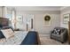 Relaxing main bedroom with tasteful decor, natural light, and a comfortable chair for unwinding at 334 Deodora Ln, Cameron, NC 28326