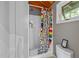 Bright bathroom featuring a shower with colorful patterned curtain and a toilet at 343 Lakewood Pointe Dr, Roxboro, NC 27574