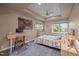 Bright bedroom featuring a ceiling fan, stylish decor, and natural light streaming through the windows at 343 Lakewood Pointe Dr, Roxboro, NC 27574