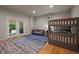 Cozy bedroom featuring a bunk bed, gray sofa and double doors to the outside at 343 Lakewood Pointe Dr, Roxboro, NC 27574