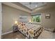 Inviting bedroom featuring a tray ceiling and a colorful quilt at 343 Lakewood Pointe Dr, Roxboro, NC 27574