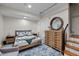 Cozy bedroom with a warm color palette, comfortable bed, dresser and a round mirror at 343 Lakewood Pointe Dr, Roxboro, NC 27574