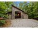 Covered boat garage nestled among the trees offers secure storage and protection from the elements at 343 Lakewood Pointe Dr, Roxboro, NC 27574