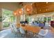 Bright dining room with hardwood floors, modern light fixtures, a fireplace and multiple windows with wooded views at 343 Lakewood Pointe Dr, Roxboro, NC 27574