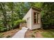 Modern detached studio with stone accents and lush landscaping at 343 Lakewood Pointe Dr, Roxboro, NC 27574