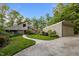 Beautiful home featuring professional landscaping, mature trees, and driveway at 343 Lakewood Pointe Dr, Roxboro, NC 27574