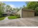 Stunning home featuring a two-car garage, mature trees, professional landscaping, and driveway at 343 Lakewood Pointe Dr, Roxboro, NC 27574