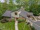 Contemporary home with meticulously landscaped yard, stone accents, and unique architectural details at 343 Lakewood Pointe Dr, Roxboro, NC 27574