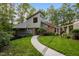 Charming home featuring professional landscaping, beautiful stone accents, mature trees, and walkway at 343 Lakewood Pointe Dr, Roxboro, NC 27574