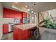 Bright kitchen featuring a large island, modern appliances, and sleek red cabinetry at 343 Lakewood Pointe Dr, Roxboro, NC 27574
