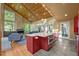 Bright, open kitchen with an island, wooden ceiling, fireplace, and views of the living area at 343 Lakewood Pointe Dr, Roxboro, NC 27574