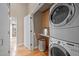 Laundry room features a stacked washer and dryer with folding counter and storage cabinet at 343 Lakewood Pointe Dr, Roxboro, NC 27574