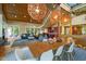 Open concept living and dining area showcasing wood ceilings, modern lighting, hardwood floors and ample natural light at 343 Lakewood Pointe Dr, Roxboro, NC 27574
