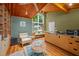 Comfortable living area with hardwood floors, kitchenette and large windows with view of trees at 343 Lakewood Pointe Dr, Roxboro, NC 27574