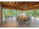 Enclosed porch featuring tile flooring, comfortable seating, and views of the surrounding landscape at 343 Lakewood Pointe Dr, Roxboro, NC 27574
