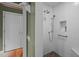 A white tiled shower features a river rock floor and built in shower niche at 343 Lakewood Pointe Dr, Roxboro, NC 27574