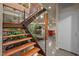 Modern staircase is trimmed with natural wood and lined with greenery at 343 Lakewood Pointe Dr, Roxboro, NC 27574