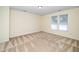 Bright bedroom featuring two windows and neutral carpeting at 4009 Patriot Ridge Ct, Raleigh, NC 27610