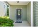 Inviting covered front door with decorative glass, fresh paint, and tidy landscaping at 4009 Patriot Ridge Ct, Raleigh, NC 27610