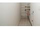 Hallway with storage shelving, tiled flooring, and neutral colored walls at 4009 Patriot Ridge Ct, Raleigh, NC 27610