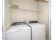 Bright laundry room featuring a washer, dryer, and wire shelving for ample storage space at 4009 Patriot Ridge Ct, Raleigh, NC 27610