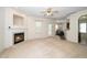 Bright living room with fireplace, neutral carpet, and ceiling fan at 4009 Patriot Ridge Ct, Raleigh, NC 27610