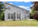 Well-maintained home exterior featuring a large patio, gray siding and an abundance of windows at 402 Halls Mill Dr, Cary, NC 27519