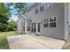 Spacious patio area for entertaining, showcasing the home's gray siding, windows, and outdoor access at 402 Halls Mill Dr, Cary, NC 27519