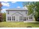 Back exterior view of the two-story home with well-manicured lawn and patio at 402 Halls Mill Dr, Cary, NC 27519