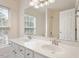 Bright bathroom featuring a double sink vanity, framed mirror, and a sunlit window view at 402 Halls Mill Dr, Cary, NC 27519