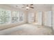 Large bedroom with a ceiling fan and triple windows for natural light at 402 Halls Mill Dr, Cary, NC 27519