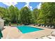 Serene community pool surrounded by lush greenery and lounge chairs, creating a relaxing atmosphere at 402 Halls Mill Dr, Cary, NC 27519
