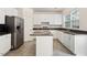 Well-lit kitchen features a center island, stainless steel appliances and white cabinetry at 402 Halls Mill Dr, Cary, NC 27519