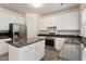 Modern kitchen featuring granite counters, stainless steel appliances, and an island for meal prep at 402 Halls Mill Dr, Cary, NC 27519