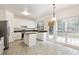 Bright kitchen features an island, stainless steel appliances and a large window offering ample natural light at 402 Halls Mill Dr, Cary, NC 27519