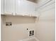 Functional laundry area with white cabinets above and hookups for the washer and dryer at 402 Halls Mill Dr, Cary, NC 27519
